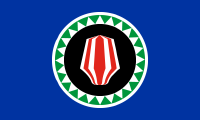 blue, red headdress, black circle surrounded by green and white triangles